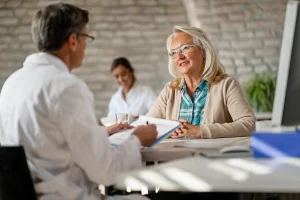 older women asking doctor for insurance on medical insurance