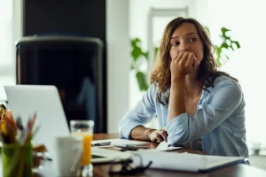 Woman reviewing her budget and considering health insurance costs at home