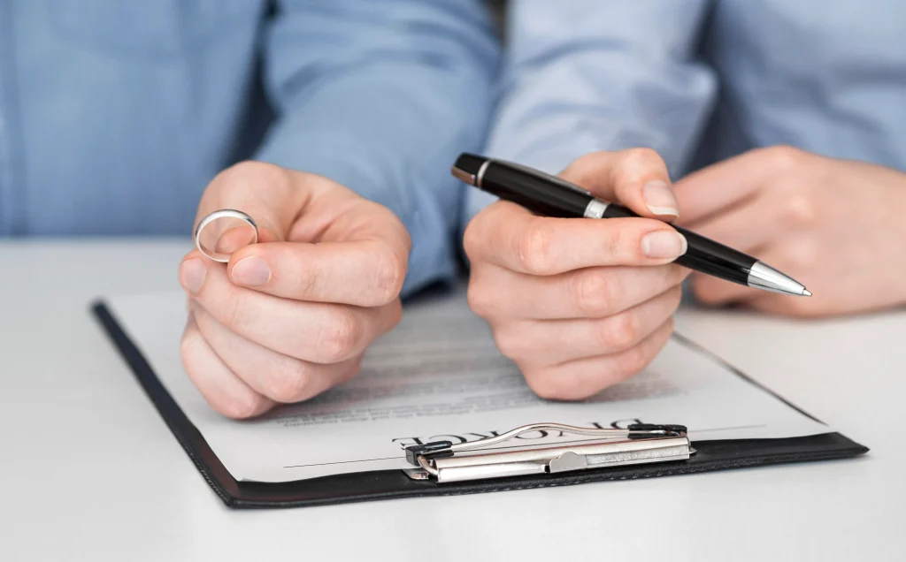 close up of couple signing divorce contract