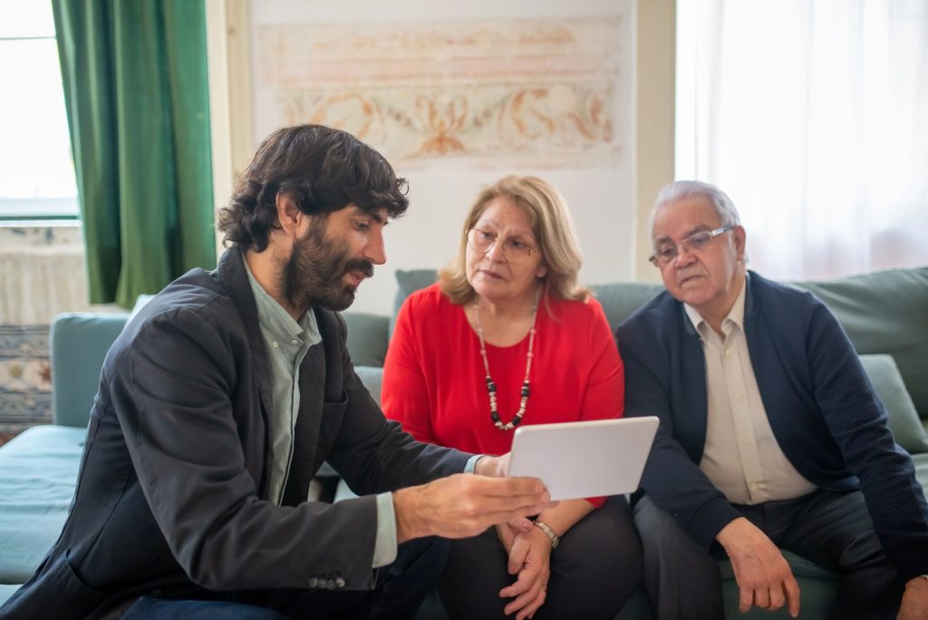 Insurance advisor explaining employee benefits and coverage options to an older couple